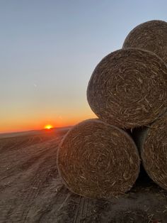 hay bales are stacked on top of each other at sunset