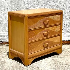 a wooden dresser sitting on top of a sidewalk