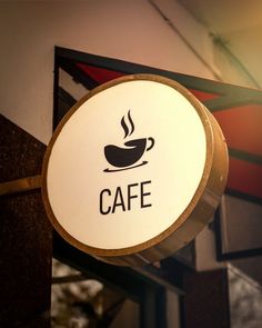 a coffee sign hanging from the side of a building