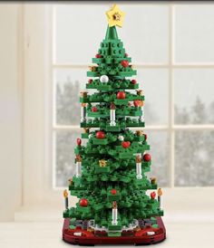 a christmas tree made out of legos in front of a window