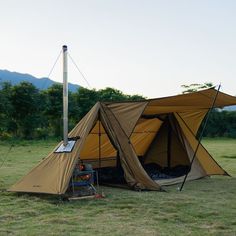 a tent set up in the middle of a field