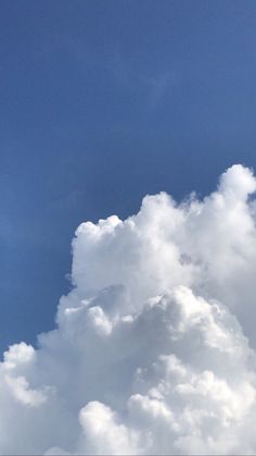 the plane is flying high in the blue sky with white clouds behind it and an airplane on the right side