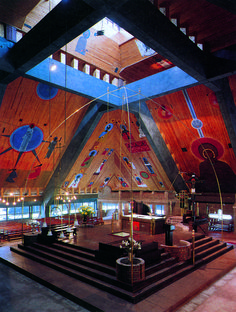 the inside of a church with wooden ceilings and stained glass windows, decorated with musical instruments