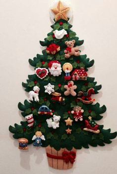 a christmas tree made out of felt with teddy bears and other decorations on it's top