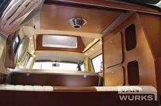 the inside of an rv with wood paneling