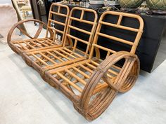 a bamboo bed frame sitting on top of a floor next to other furniture and decor