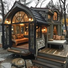 a small house built into the side of a wooden deck