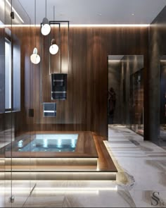 a bathroom with a glass bathtub and lights on the ceiling, along with marble flooring