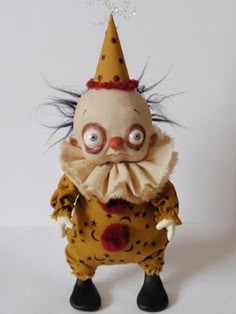 a creepy looking doll wearing a party hat