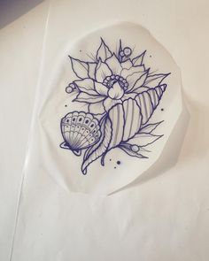 a white plate with blue designs on it sitting on top of a paper towel next to a pen and ink