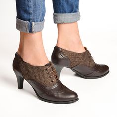 Crafted from dark brown leather with canvas accents, these oxfords offer a unique twist on a classic style. The kitten heel provides a subtle lift while ensuring all-day wearability, perfect for both professional and casual settings. Featuring rounded almond toes for a sleek and elegant look, and adorned with delicate brogue detailing, these oxfords exude timeless charm and refinement.  PRODUCT INFO: Premium leather upper and canvas Ultra smooth nappa leather lining Non-slip recycled rubber outs Retro Brown Leather Lace-up Shoes, Fitted Leather Sole Oxfords For Fall, Fitted Brown Oxfords With Rubber Sole, Elegant Brown High Heel Lace-up Shoes, Brown Pointed Toe Court Shoes With Leather Sole, Brown Pointed Toe Court Shoes With Rubber Sole, Retro Wingtip Oxfords For Fall, Brown Brogue Lace-up Shoes For Office, Vintage Oxfords For Fall Office Wear