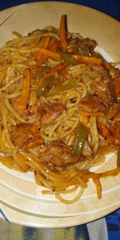 a white plate topped with pasta and vegetables