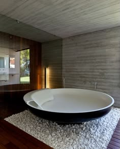 a large white bath tub sitting inside of a bathroom