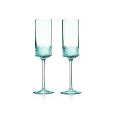 two empty wine glasses sitting next to each other