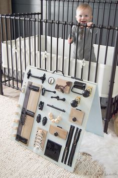 a baby in a crib surrounded by various items