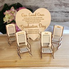 four miniature chairs and a heart shaped plaque with the words our loved one on it