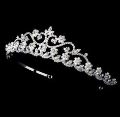 Delicate and elegant, this tiara can complete the most sophisticated of bridal looks. Adorned with iridescent pearls and intricately faceted clear cubic zirconia on a bright silver base, it has an incredible sparkle that coordinates with any color wedding dress or formal ensemble. Cast in lightweight alloy and rhodium plated for a flawless finish, the headband measures 1.75" at the tallest point (approx. 4.5cm) and 5.5" across (approx. 14cm). Two small loops at each end make it easy to attach to Tiara Headpieces, Pearl Bridal Headband, Pearl Flowers, Crystal Bridal Tiaras, Bride Tiara, Hair Accessories Pearl, Headband Tiara, Crystal Tiaras, Pearl Bridal