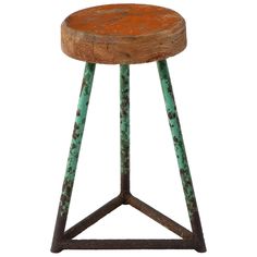 an old wooden stool with rusted paint on the top and bottom, sitting against a white background