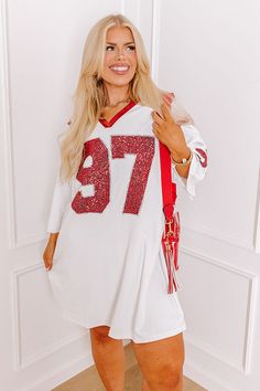 - Activate game day mode with this trendy mini dress! It's effortlessly stylish sequined design adds the perfect amount of sparkle. Bring glam to the game with this adorable dress. Get the Game Day essentials for the Alabama Crimson Tide, Arkansas Razorbacks, Arkansas State Red Wolves, Texas A&M Aggies, Texas Tech Red Raiders, University of Georgia Bulldogs, University of Oklahoma Sooners, or the University of Louisville Cardinals teams. - Sleek, stretchy faux leather material - A v-cut neckline Fall White Sequin Dress, White Sequin Dress For Fall, White V-neck Sequin Dress, White Sequin Dresses For Fall, White Mini Dress With Contrast Sequin For Night Out, White Contrast Sequin Mini Dress, White Mini Length Sequin Dress, White Long Sleeve Sequin Dress For Party Season, White Long Sleeve Sequin Dress For Party