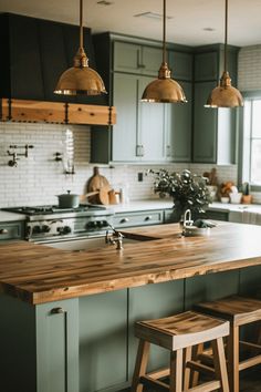 a kitchen with green cabinets and wooden stools