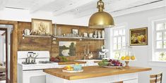 a kitchen with white appliances and wooden counters