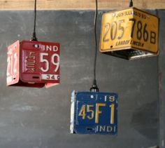 three different license plates hanging from the ceiling