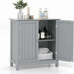 a gray cabinet with some bottles and soaps on it's shelf next to a potted plant