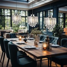 a dining room table with blue chairs and chandeliers