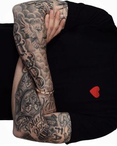 a man with tattoos covering his face and arm