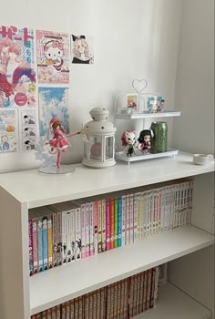 a shelf with books and figurines on it