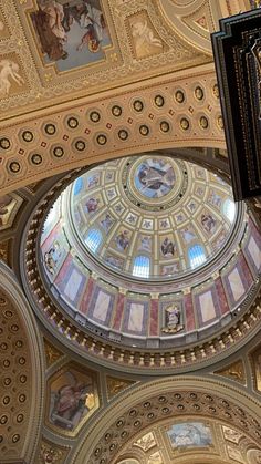 an ornate ceiling in a building with paintings on it