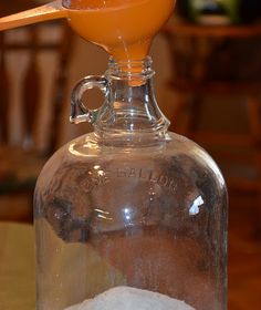 an old fashioned glass bottle filled with sugar and orange liquid