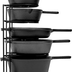 a stack of black pots and pans on a metal rack