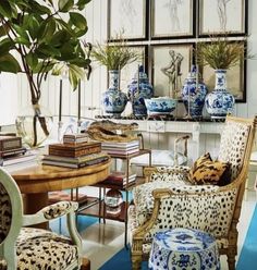 a living room filled with lots of furniture and vases on top of a table