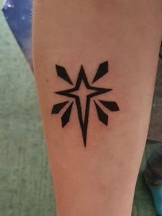 a tattoo on the leg of a person with a star in it's center