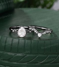 a close up of a ring on top of a green tire rim with leaves in the background