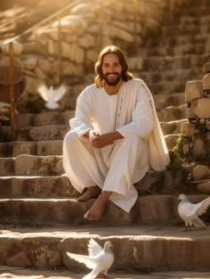 a man sitting on some steps next to white birds and doves in the air