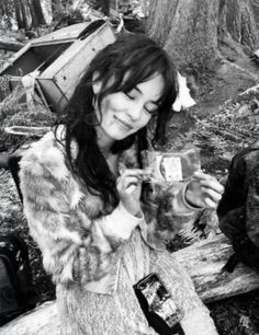 black and white photograph of a woman holding a bird in her hands while another man looks on