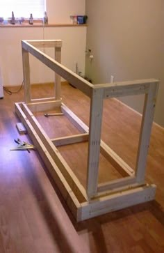 an unfinished room with wood flooring and construction materials on the ground in front of it