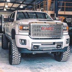 a white truck parked inside of a garage