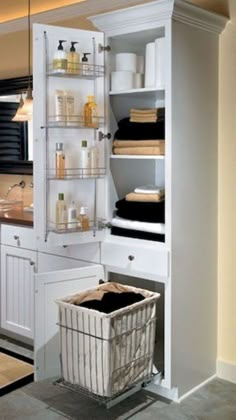 a white cabinet with shelves and baskets in it