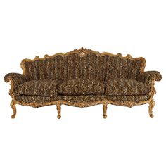 an old fashioned couch with ornate carvings on the armrests and back, against a white background