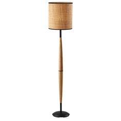 a wooden floor lamp with a black base and a light shade on it's side