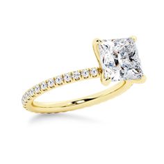 a yellow gold ring with a princess cut diamond