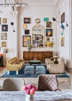 a living room filled with furniture and pictures on the wall