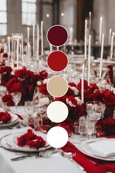 the table is set with red and white flowers