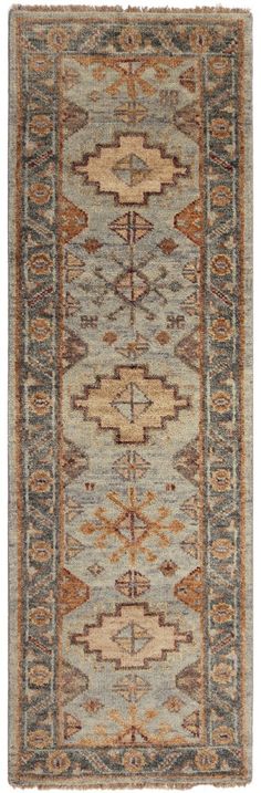 an antique rug with blue, beige and brown colors on the bottom half of it