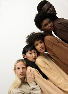 three women are posing for the camera with their arms around each other and one woman is leaning on her shoulder