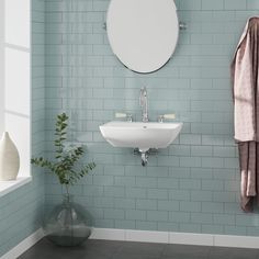 a white sink sitting under a mirror in a bathroom