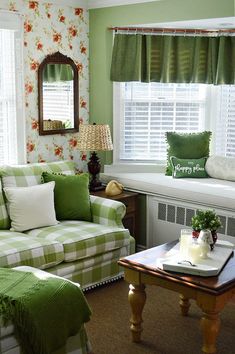 a green and white living room with floral wallpaper on the walls, window sill